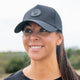 Black female trucker ponytail hat with breathable, water-resistant material and moisture-wicking bamboo headband for outdoor adventures