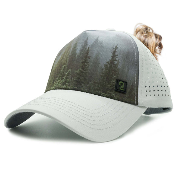 High Ponytail womens Trucker Hat with water-resistant material, breathable design, and embroidered forest pattern for outdoor adventures