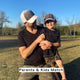 Father and son outdoors wearing matching performance Boy trucker hat and casual black and camo outfits