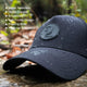Black female trucker ponytail hat with water-resistant, breathable, and durable design featuring PadSnap snapback and low profile floating brim