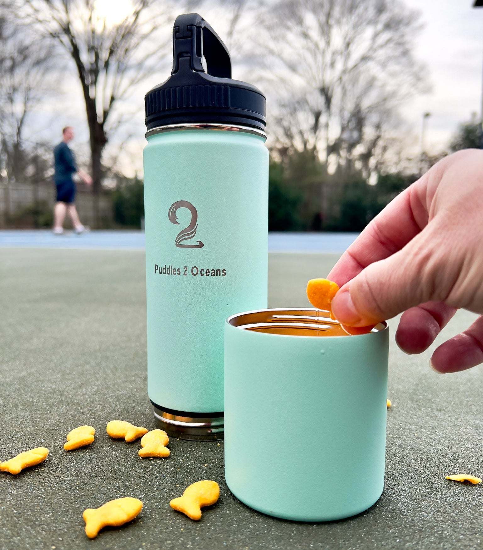 water bottle with storage container, snack being pulled out of a snack container