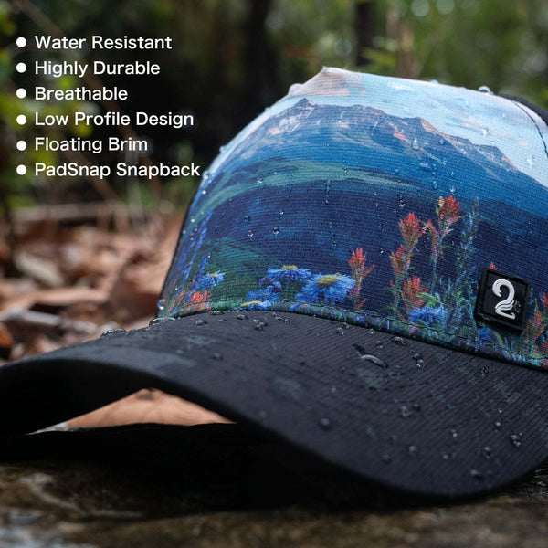 Water-resistant breathable female trucker hat with low profile design and floating brim featuring mountain scenery and PadSnap snapback